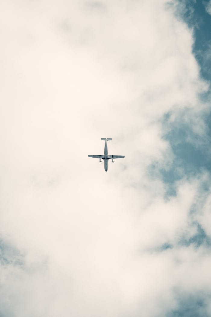 A small airplane captured against a backdrop of clouds in Villamaría, Colombia.